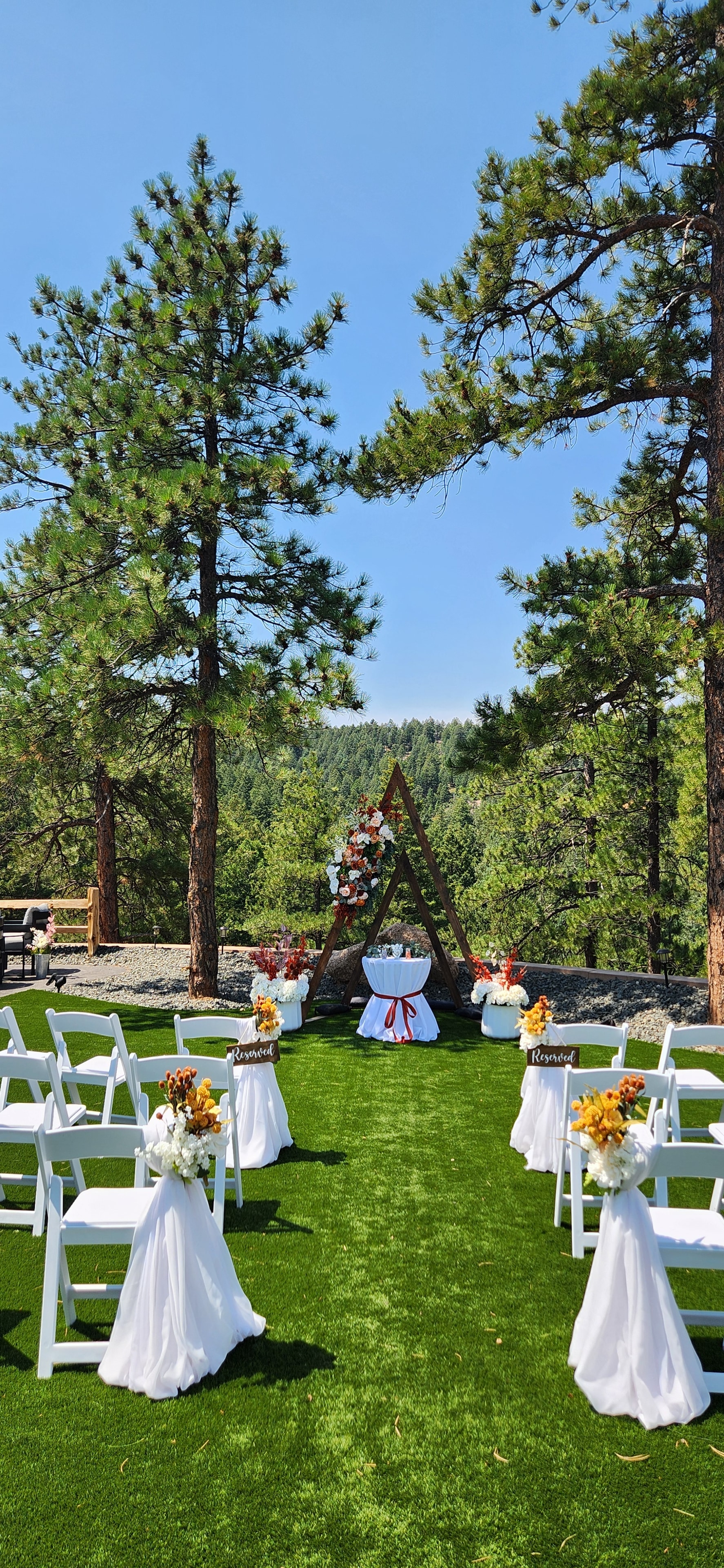 Wedding ceremony aisle with lanterns and florals